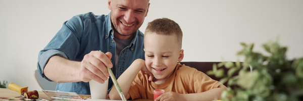 A father and young child playing together on the floor