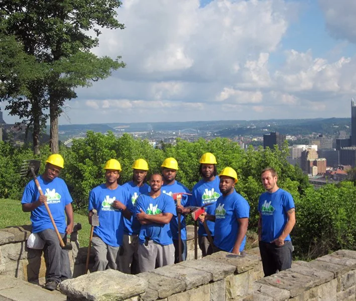 A Landforce crew above the Pittsburgh skyline at Emerald View Park