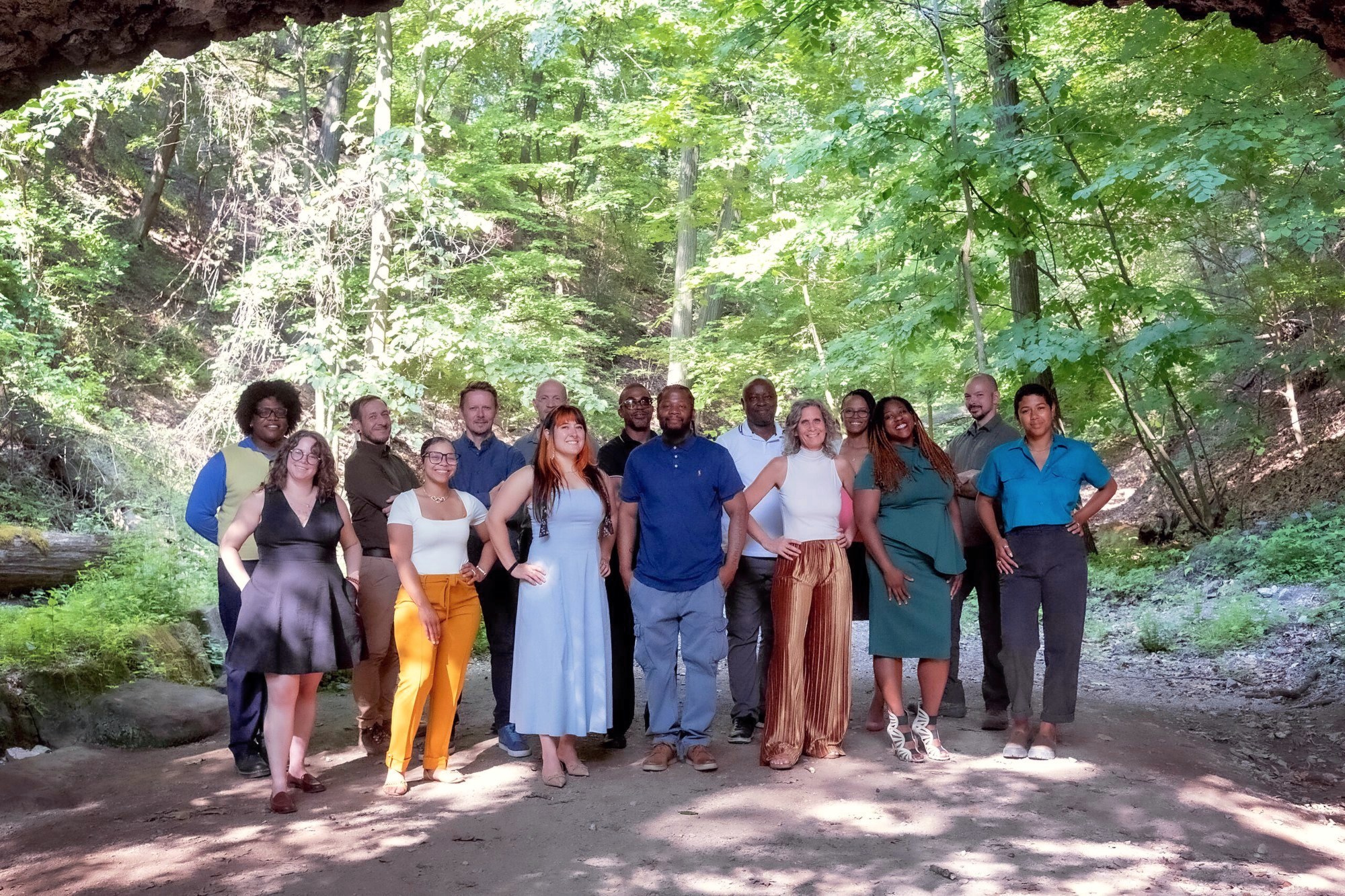 The Landforce staff team gathered under trees on a wooded park path