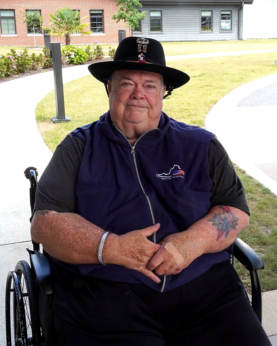 Kevin, a U.S. Army veteran and I-RIDE passenger, smiling in his wheelchair