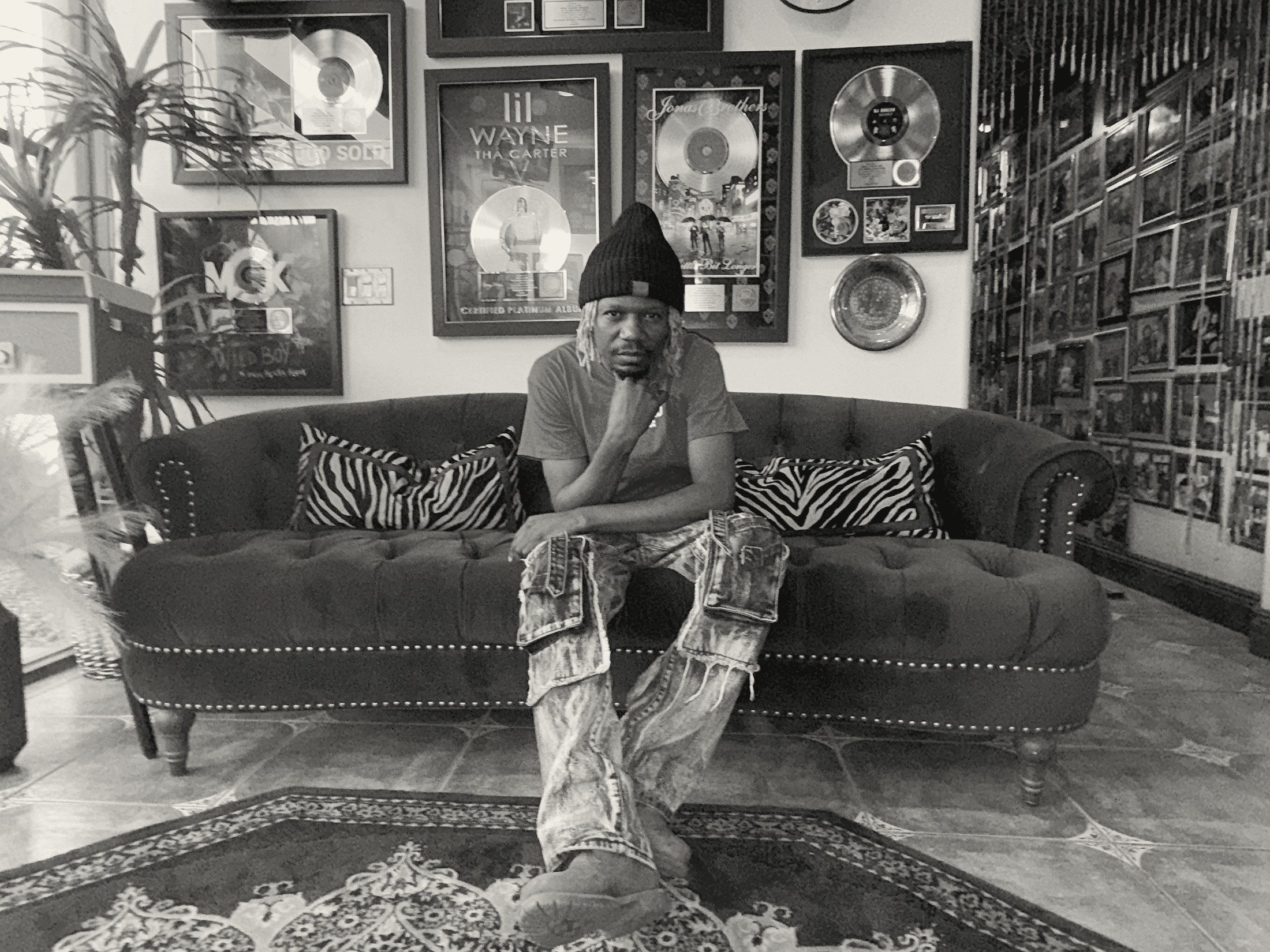 Prince Desire seated in a trophy wall lounge