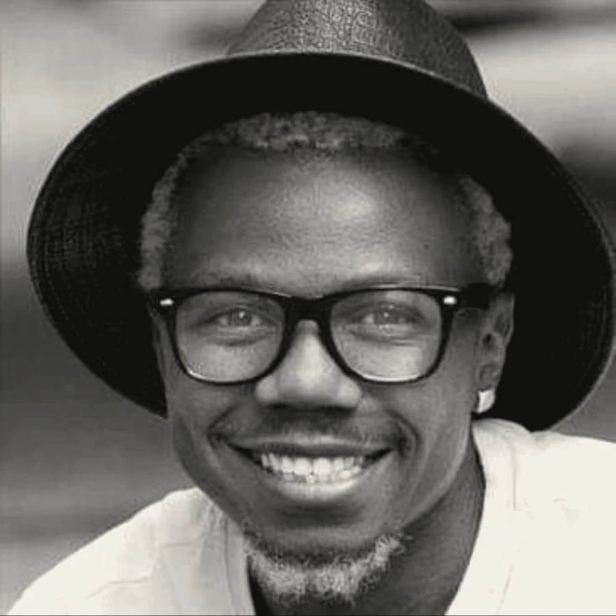 Prince in a black hat and glasses